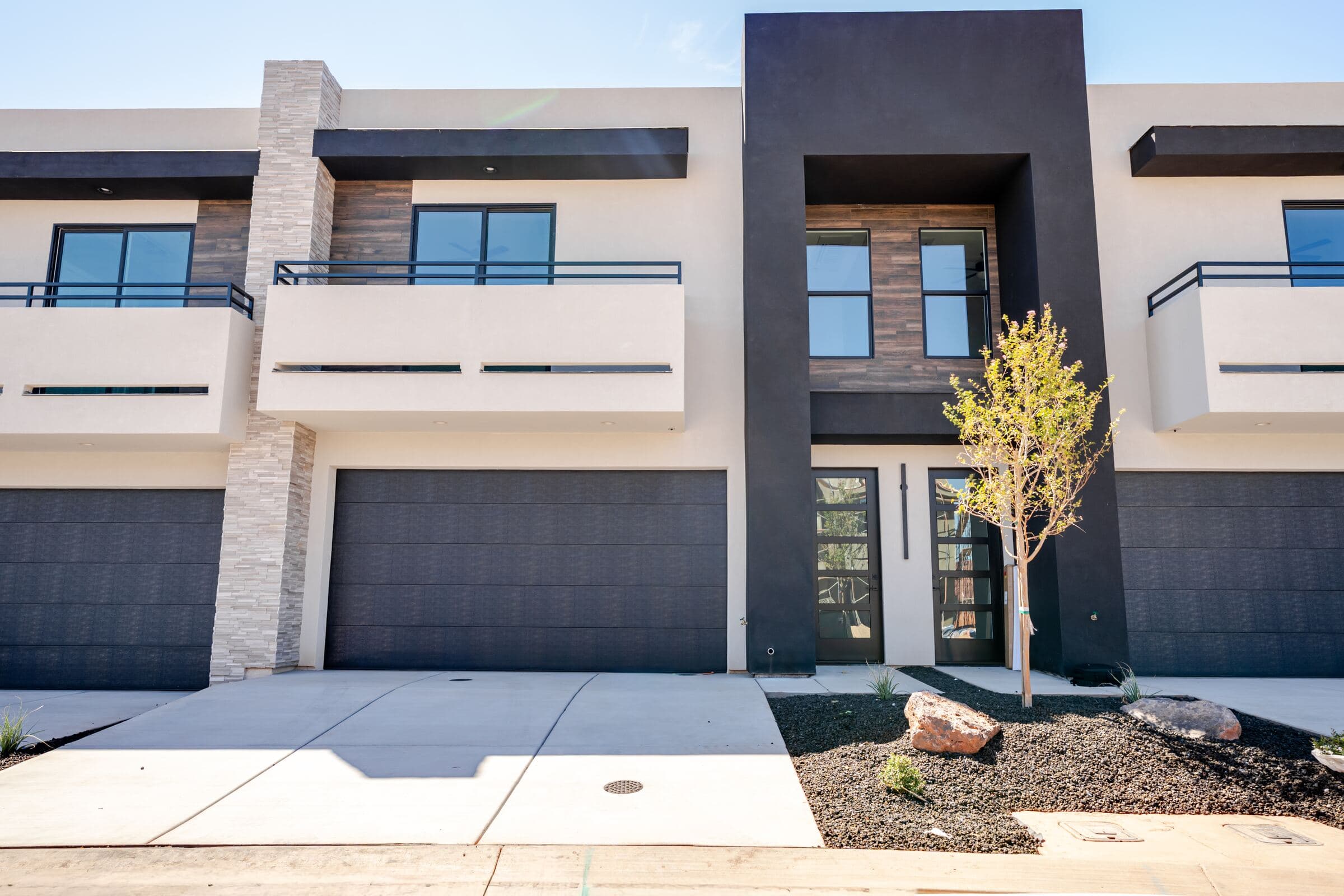 Wood-accented entry and private balconies at a Solace townhome