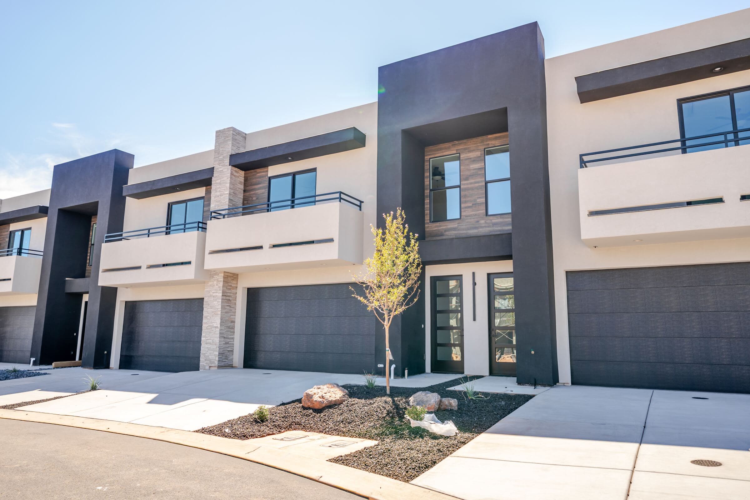 Modern townhome exteriors with attached two-car garages at Solace Townhomes